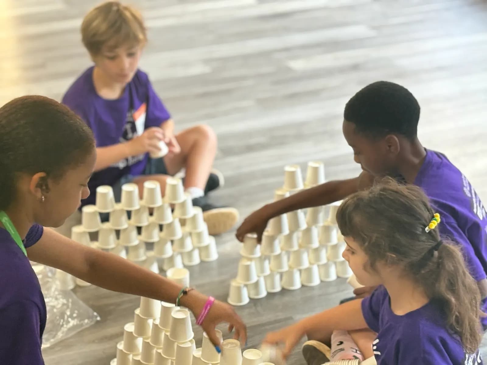Children building a cup tower
