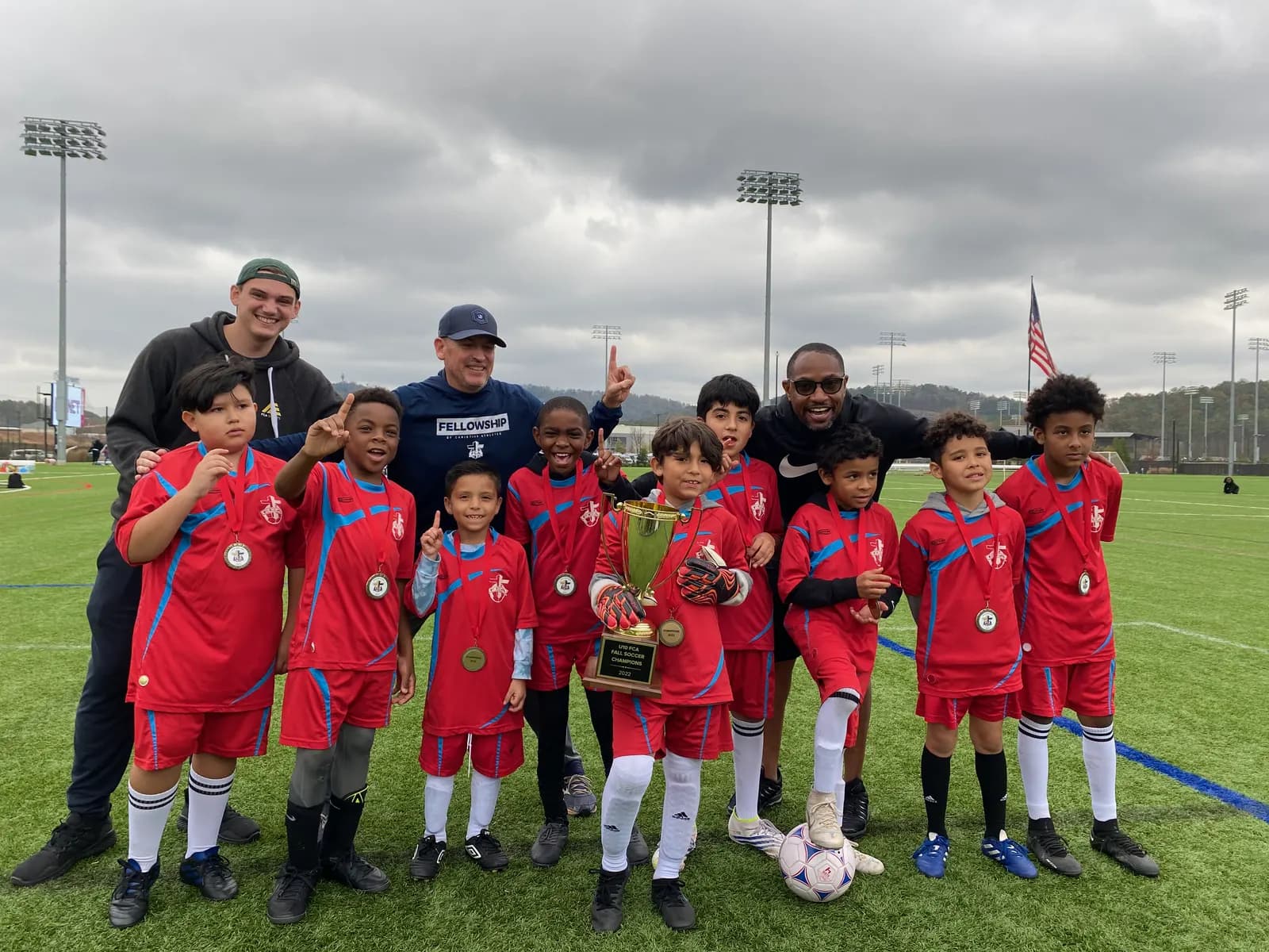 Soccer team celebrating with medals
