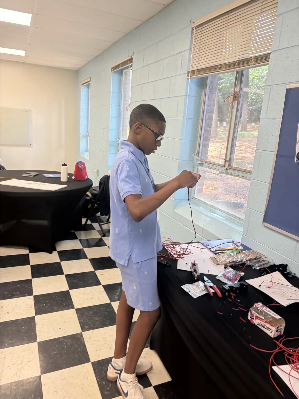 A student assembling a wiring project at the engineering camp