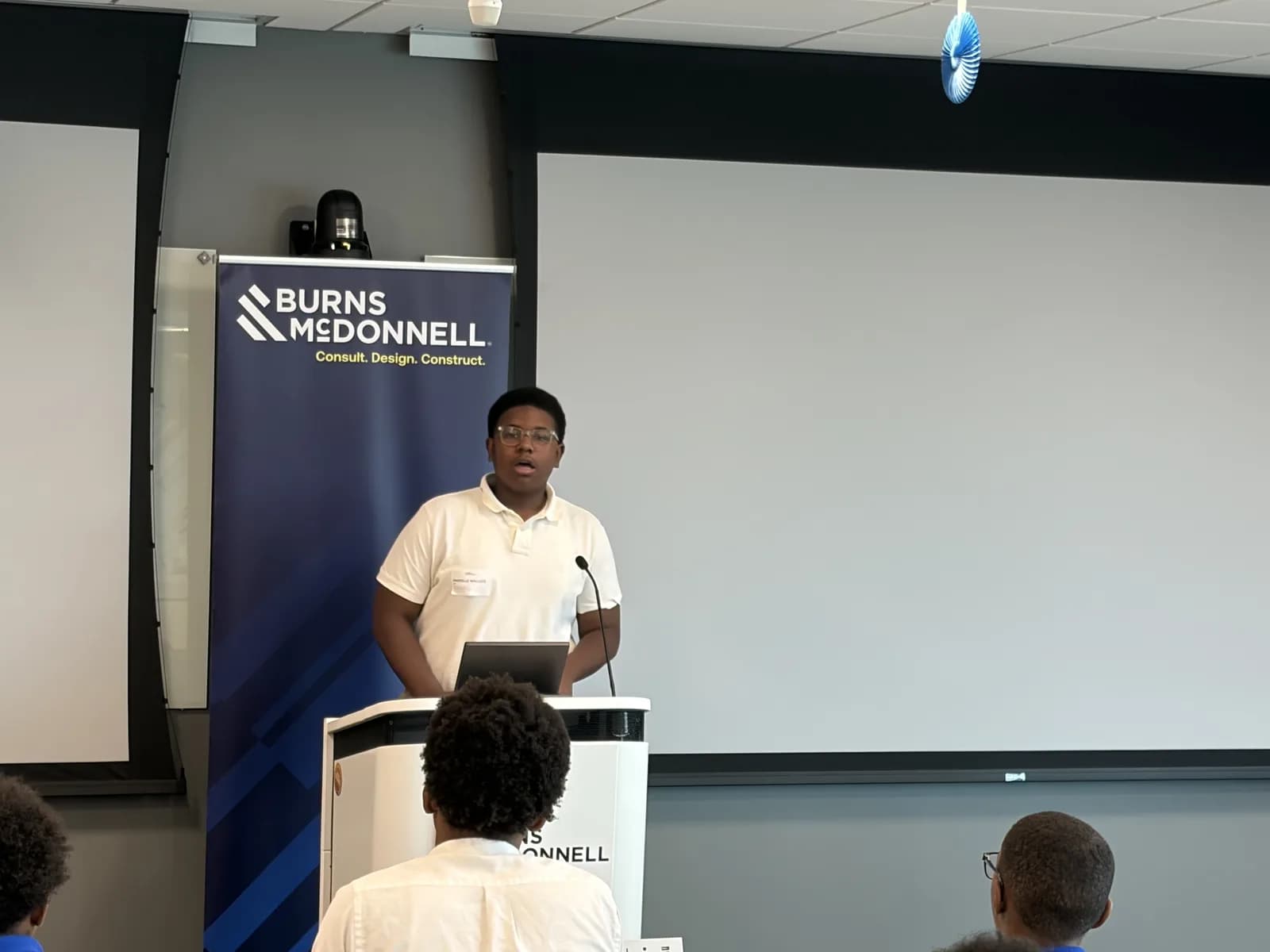 A student presenting from the podium at the engineering camp