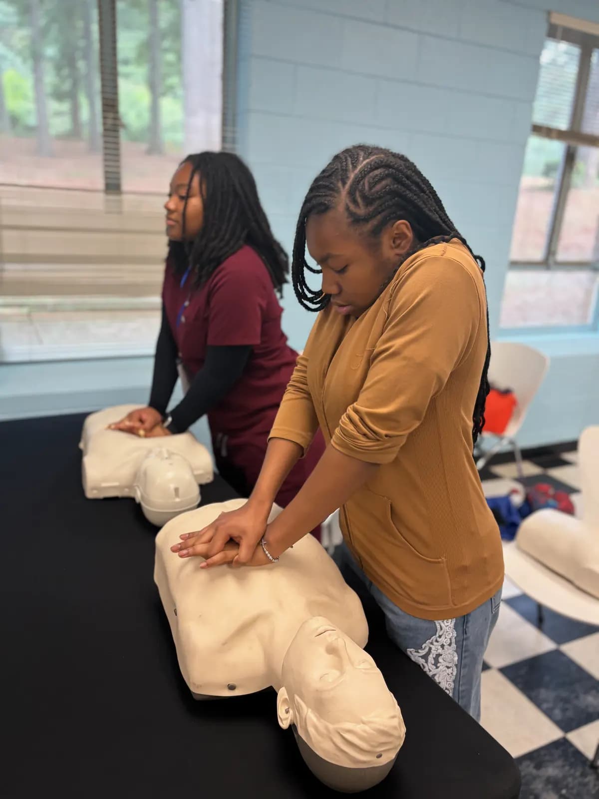 Students practising CPR on training manikins