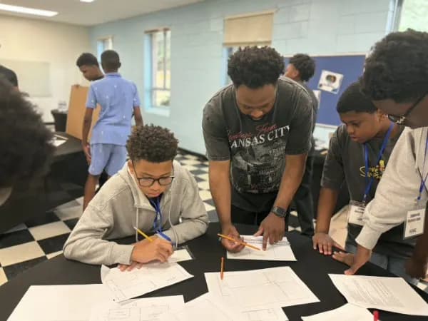 Students working through engineering drawings