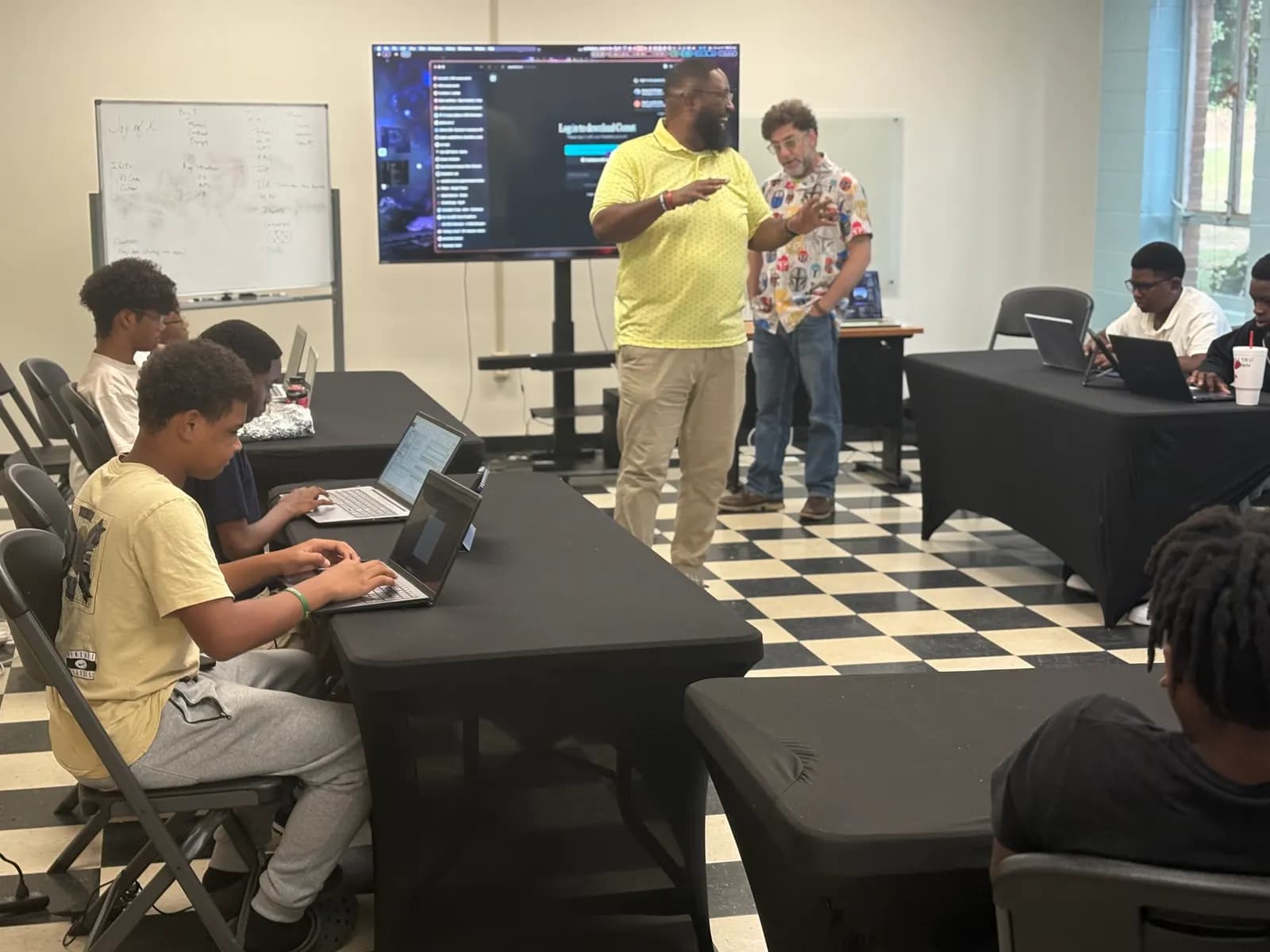 Instructor leading a laptop coding session